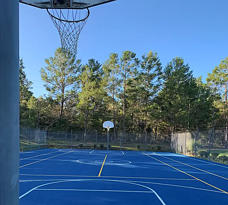 Basketball court construction in Hudson, FL: resurfaced outdoor court with acrylic coating and new striping