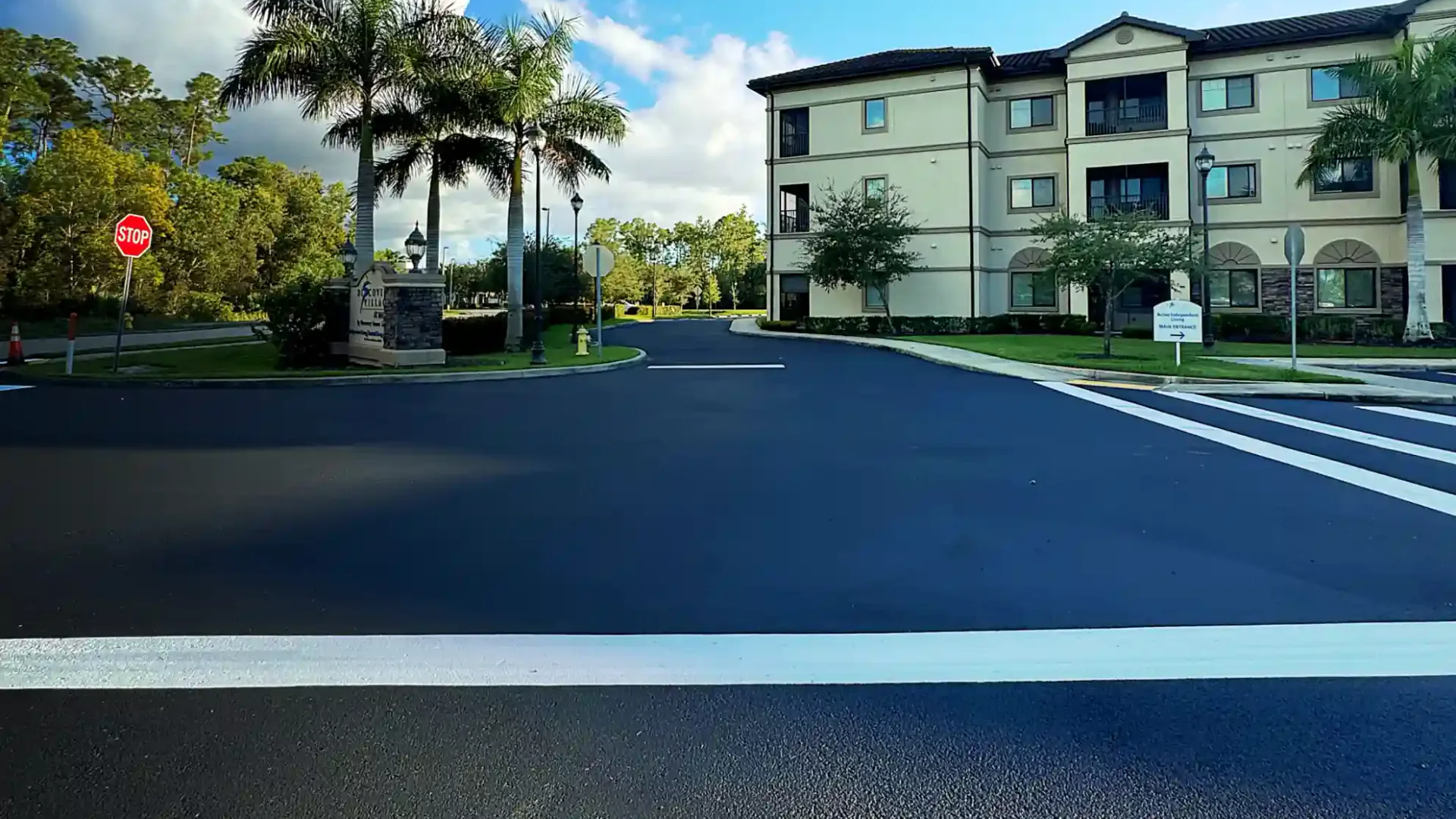 Sealcoating in Hudson, FL: freshly sealcoated and striped roadway at a managed community